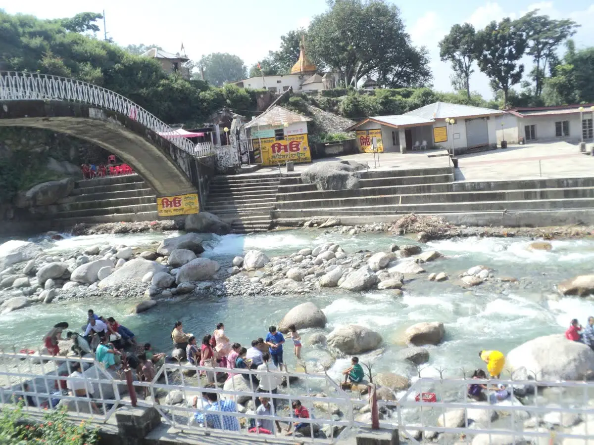 Arched footbridge and bathing steps over the stream beside Chamunda Devi temple in Kangra