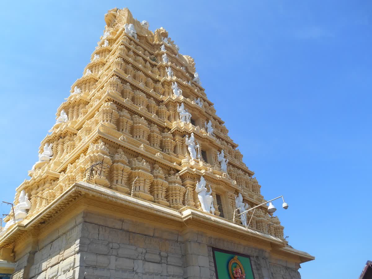 The tall carved gopuram of Chamundeshwari Temple against a blue sky