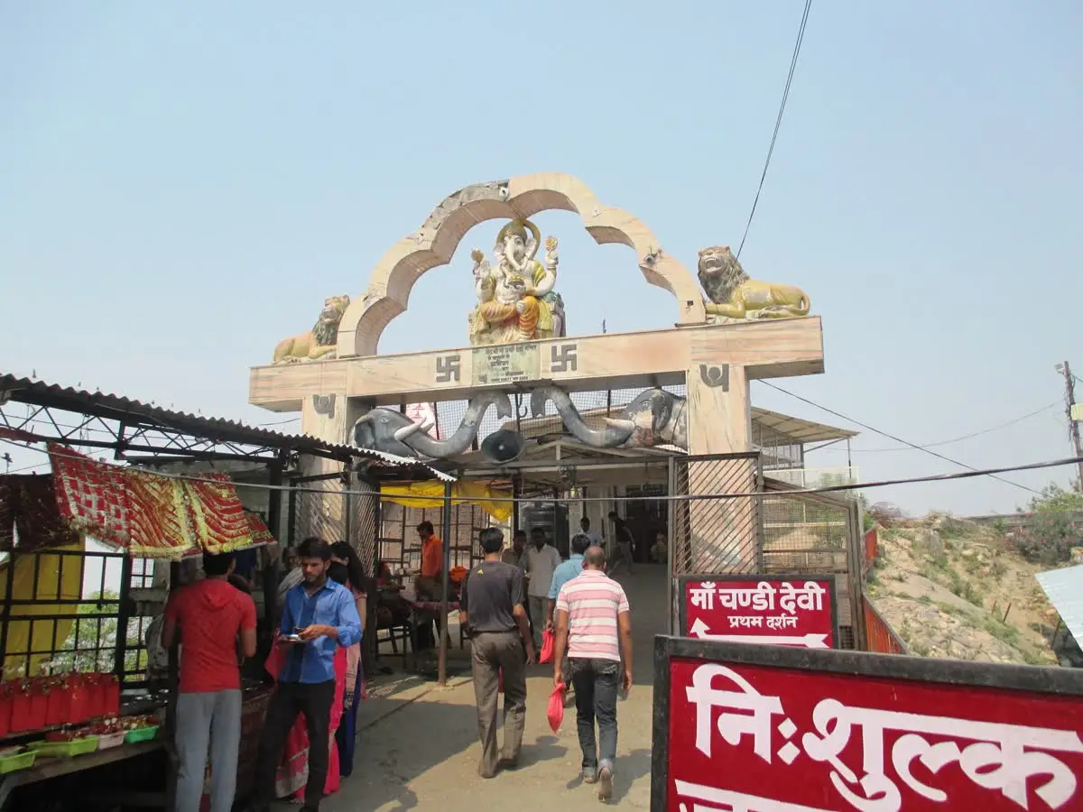 Arched entrance gate topped with a Durga figure and lions at Chandi Devi temple, Haridwar