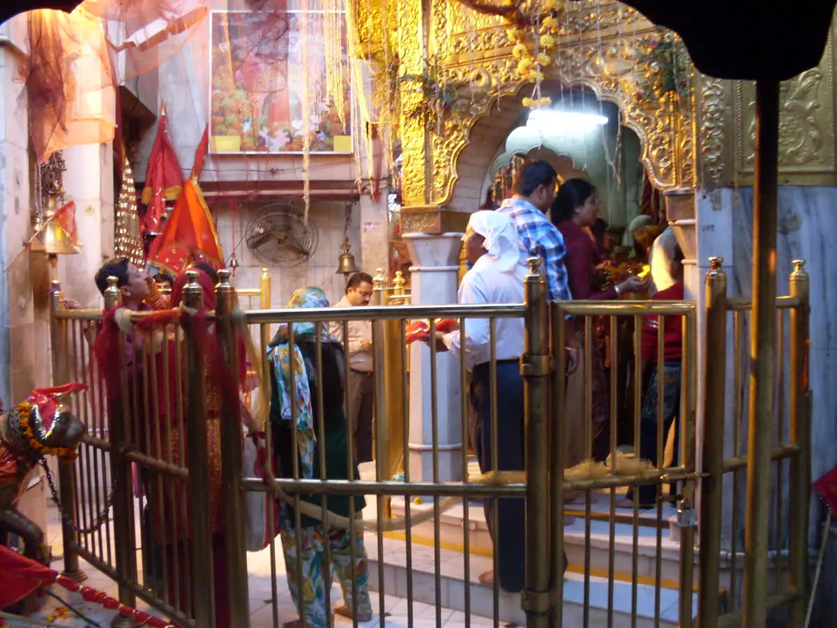 Devotees at the railed approach to the Chintpurni Devi sanctum seen from the havan kund