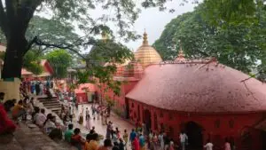 Kamakhya Temple on Nilachal Hill in Guwahati, Assam, with its red beehive-shaped dome and pilgrims in the courtyard