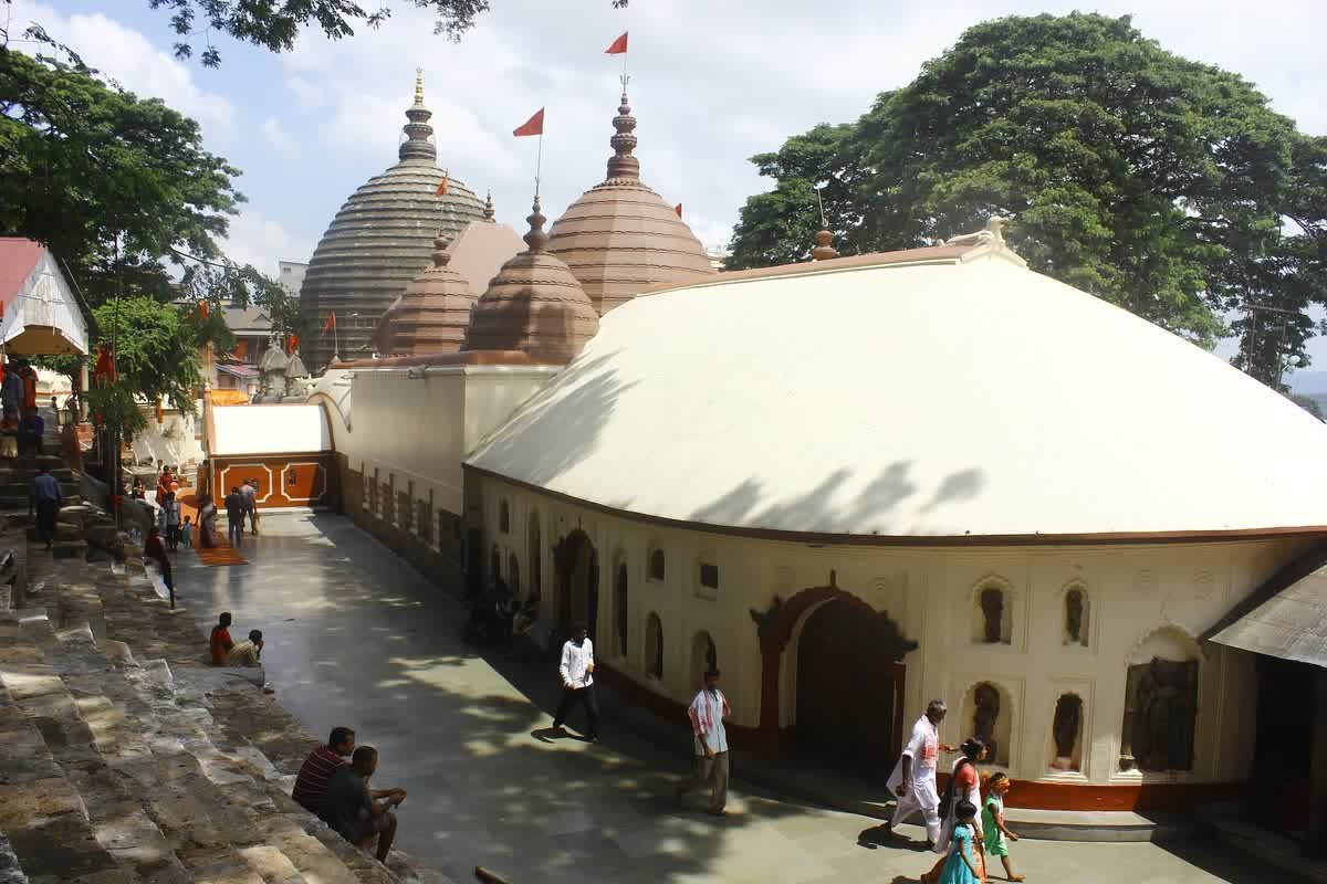 The Kamakhya Temple complex on Nilachal Hill seen from above, with its domed shrines, paved courtyard and surrounding trees