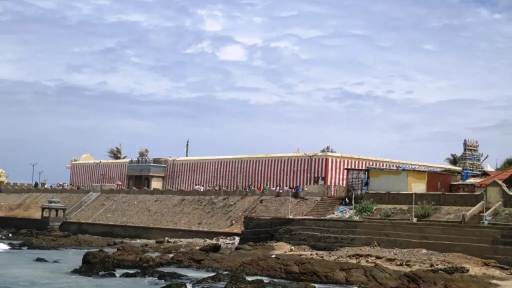 Red and white striped outer wall of the Kumari Amman temple above the Kanyakumari shore