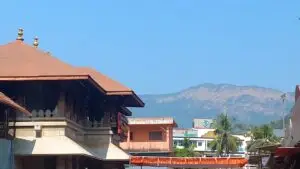 Tiled roofs of the Mookambika temple at Kollur with Western Ghats hills behind