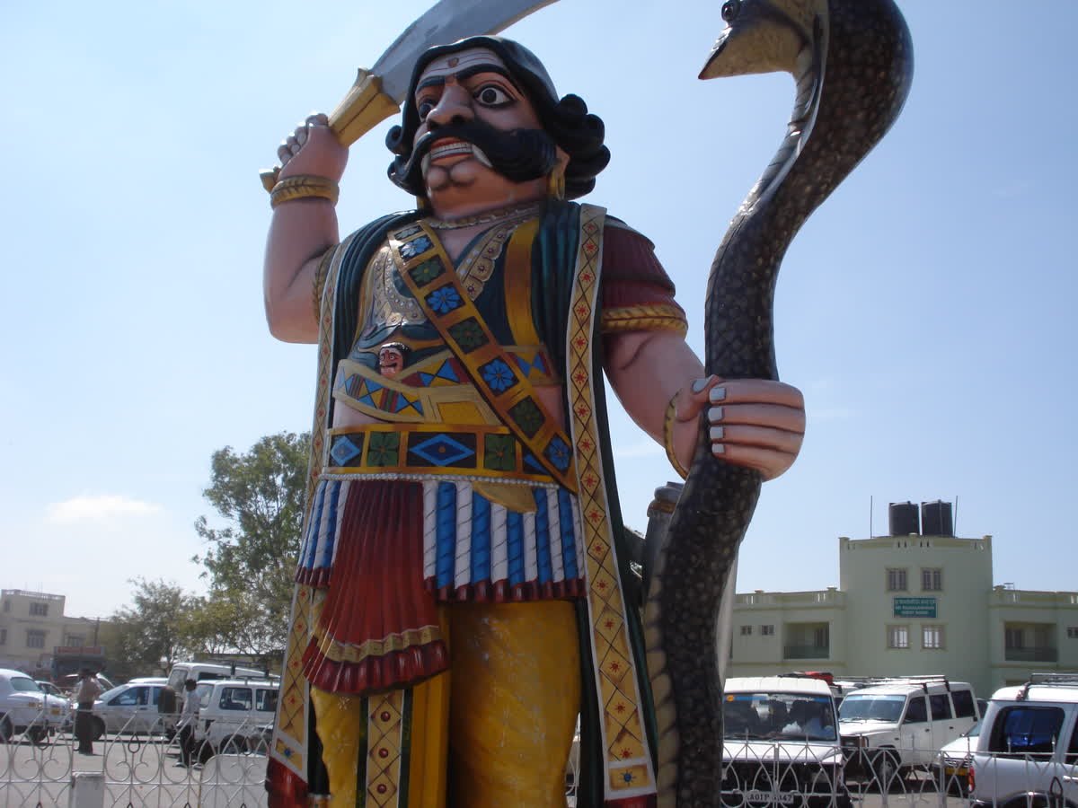 The painted statue of Mahishasura holding a sword and a snake on Chamundi Hill