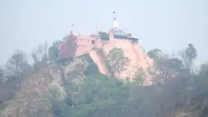 Pink Mansa Devi temple perched on Bilwa Parvat hilltop above Haridwar in haze