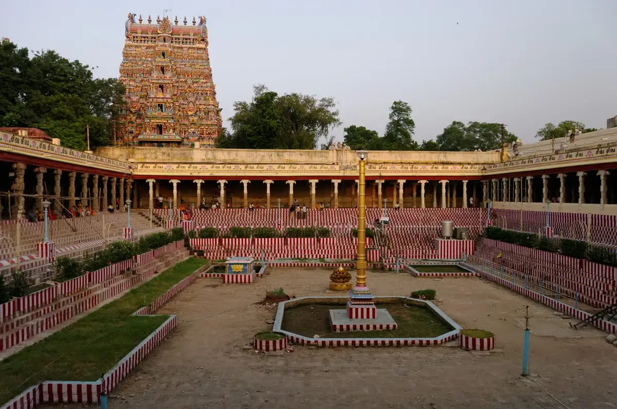 Golden Lotus tank with a gopuram of Meenakshi Amman temple rising behind its pillared walkway