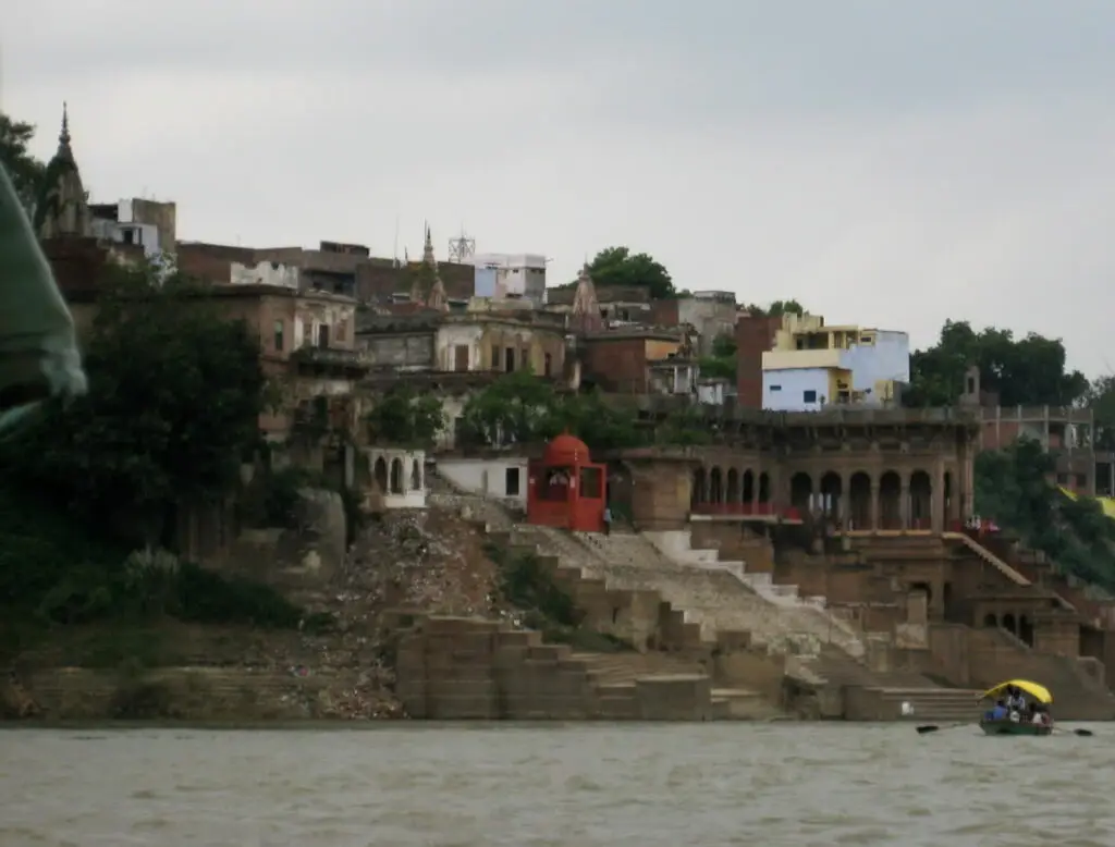 Stone ghats and old riverside buildings of Mirzapur seen from a boat on the Ganga