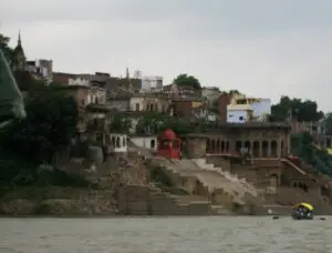 Stone ghats and old riverside buildings of Mirzapur seen from a boat on the Ganga