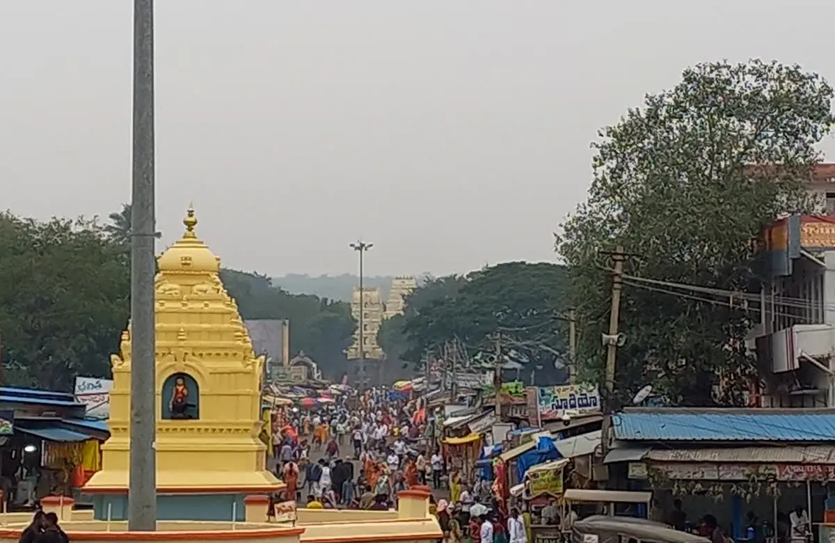 Crowd of pilgrims and shops on the road at Nandi circle approaching Srisailam temple