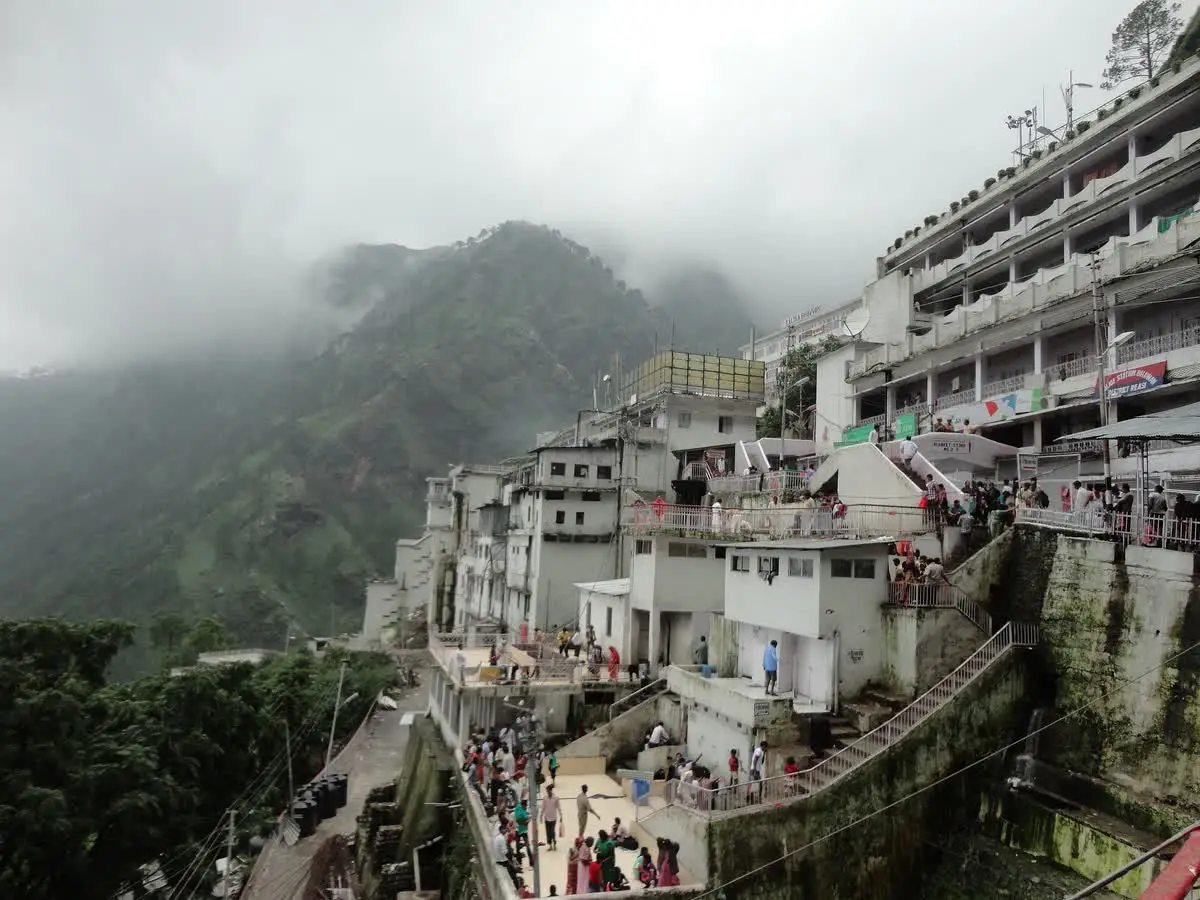 The Vaishno Devi Bhawan complex with pilgrims, partly covered in cloud